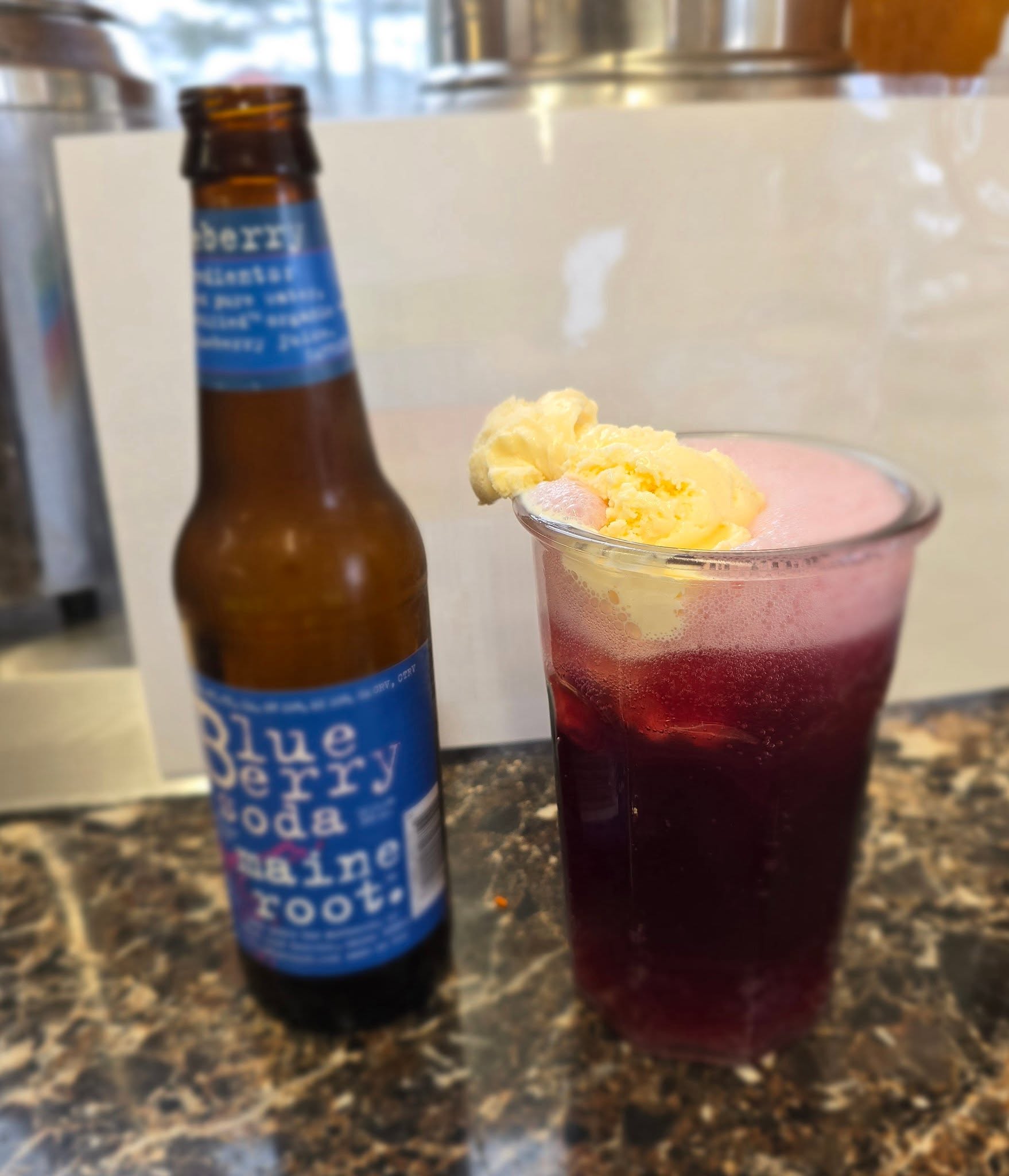 A Maine blueberry root beer float topped with a scoop of ice cream