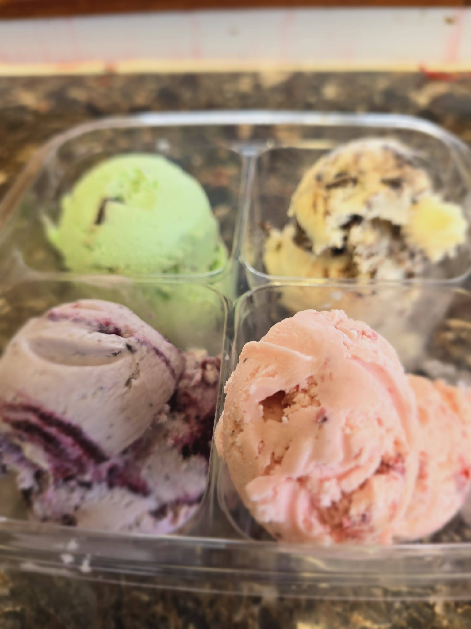 Four colorful hard-serve ice cream scoops from Blueberry Hill Dairy Bar